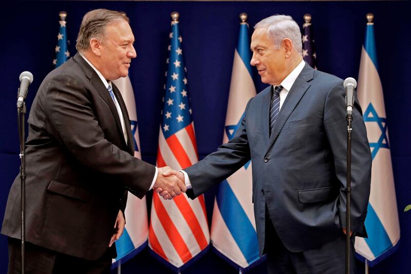 (FILES) In this file photo taken on October 18, 2019, Israeli Prime Minister Benjamin Netanyahu (R) shakes the hand of US Secretary of State Mike Pompeo following their meeting in Jerusalem. US Secretary of State Mike Pompeo was due in Israel on May 13, 2020 for talks on regional security and the Jewish state's controversial plans to annex parts of the occupied West Bank. In a rare foreign trip during the coronavirus pandemic, Pompeo planned to meet Prime Minister Benjamin Netanyahu and incoming defence minister Benny Gantz, a day before a unity government agreed between the two men is scheduled to be sworn in.
 / AFP / POOL / Sebastian Scheiner
