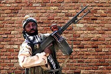 Boko Haram factional leader Abubakar Shekau holding a heavy machine gun at an undisclosed location in Nigeria. AFP.