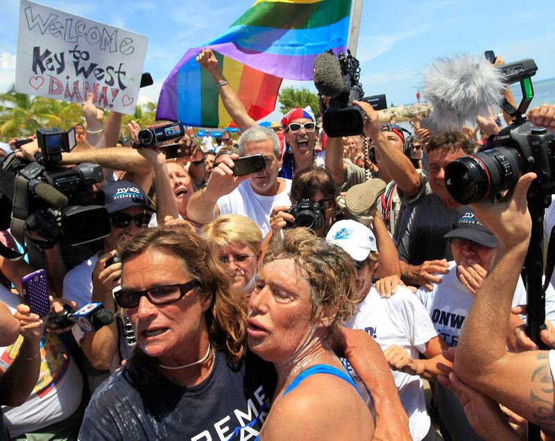 U.S. long-distance swimmer Diana Nyad (front R), 64, is welcomed ashore after completing her swim from Cuba as she arrives in Key West, Florida, September 2, 2013. Nyad has become the first person to swim from Cuba without a shark cage. REUTERS/Andrew Innerarity  (UNITED STATES - Tags: SPORT SWIMMING TPX IMAGES OF THE DAY) *** Local Caption ***  EYW103_CUBA-SWIM-DI_0902_11.JPG