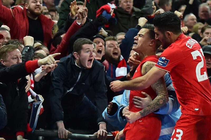 Liverpool’s Brazilian midfielder Philippe Coutinho (2R) celebrates with the crowd after scoring their first goal to equalise 1-1 during the English League Cup final football match between Liverpool and Manchester City at Wembley Stadium in London on February 28, 2016. AFP / BEN STANSALL