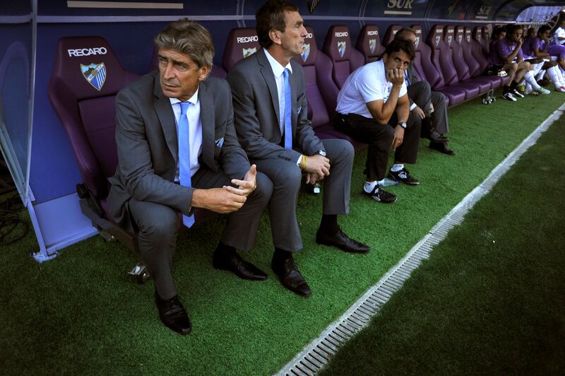 Malaga's coach Manuel Pellegrini (L) gestures prior to the Spanish league football match Malaga  vs Barcelona on May 21, 2011 at the Rosaleda stadium in Malaga.  AFP PHOTO/ JORGE GUERRERO