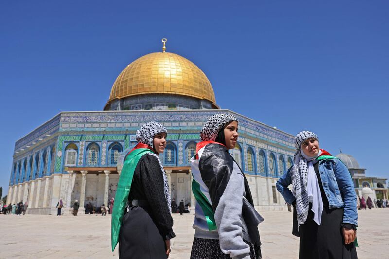 Palestinian girls in front of the Dome of the Rock mosque in Jerusalem's Old City. AFP