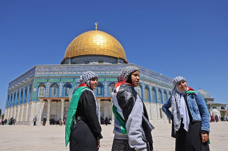 Palestinian girls in front of the Dome of the Rock mosque in Jerusalem's Old City. AFP