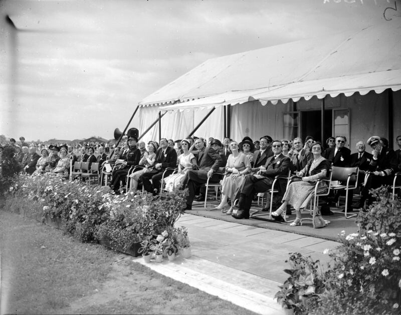 Farnborough Airshow crowds and dignitaries watch RAF Hawker Hunter jets perform a display in honour of the Royal Aircraft Establishment's jubilee in 1955.