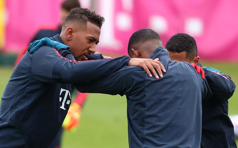 Bayern Munich's Jerome Boateng and teammates do stretching exercises. Reuters