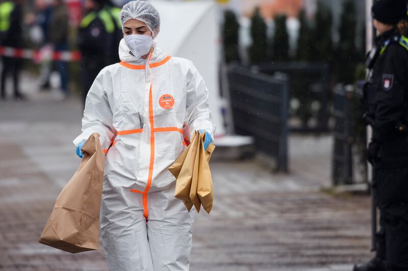 Forensic staff collect evidence. Getty