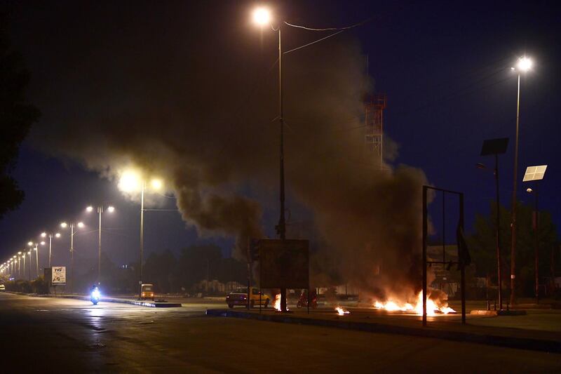 Demonstrators burn tires as they block a road in Al Sadr city, eastern Baghdad, Iraq.  EPA