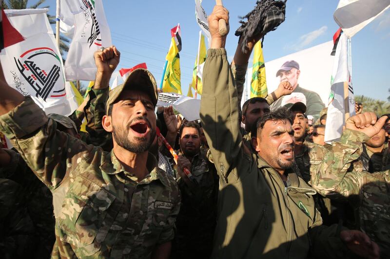Members of the Hashed al-Shaabi paramilitary force chant anti-US slogans during a protest over the killings of Iranian commander Qassem Soleimani and Iraqi paramilitary commander Abu Mahdi Al-Muhandis, on January 6, 2020 in Karrada in central Baghdad. / AFP / AHMAD AL-RUBAYE
