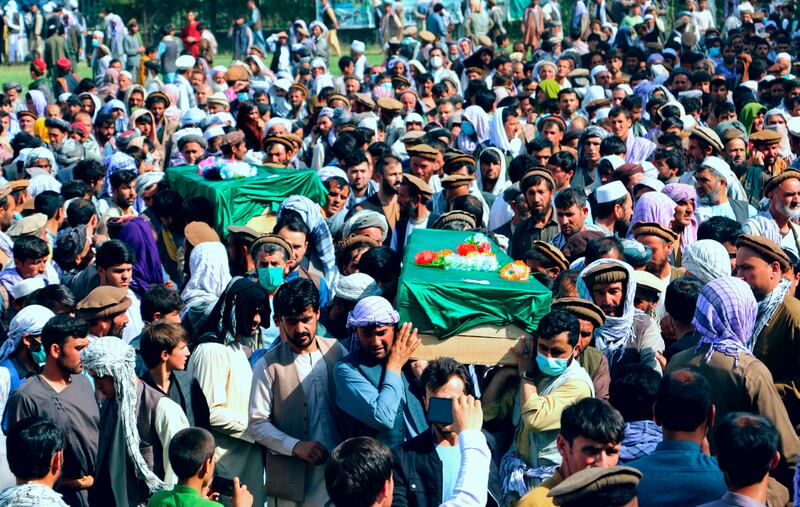 Afghans carry the body of civilians killed during fighting between the Taliban and national security forces in Badakhshan province, northern Afghanistan, on July 4, 2021.  AP
