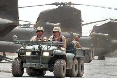 US soldiers drive past Chinook helicopters at Bagram air base in 2002. American forces have started pulling out of two bases in Afghanistan, a US official said on Tuesday. AFP