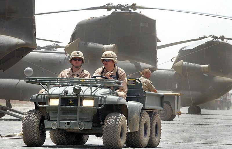 (FILES) In this file photo taken on July 2, 2002, US soldiers drive past Chinook helicopters at Bagram air base.  American forces have started pulling out of two bases in Afghanistan, a US official said on March 10, the day peace talks between Kabul and the Taliban were due to start despite widespread violence and a political crisis. The United States is keen to end its longest-ever conflict, and under the terms of a deal signed in Doha last month has said all foreign forces will quit Afghanistan within 14 months -- provided the Taliban stick to their security commitments.
 - 
 / AFP / JEWEL SAMAD
