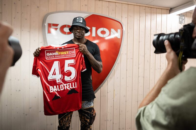 Italy striker Mario Balotelli poses with a FC Sion shirt. AFP
