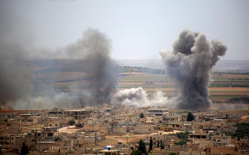 Plumes of smoke rise following reported Syrian government forces' bombardment on the town of Khan Sheikhun in the southern countryside of the jihadist-held Idlib province, on June 6, 2019. / AFP / Anas AL-DYAB
