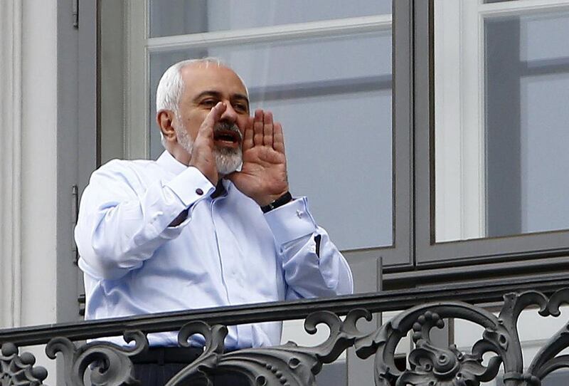 Iranian foreign minister Mohammed Javad Zarif talks to journalists as he stands on the balcony of the Coburg hotel, the venue for nuclear talks, in Vienna on July 13. Reuters