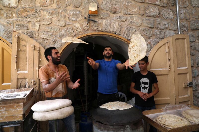 Palestinian bakers prepare 'Saj' bread, in  Hebron, Palestine.  EPA