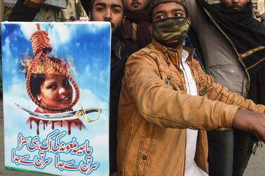 In this file photo taken on February 1, 2019 Pakistani Islamists hold a poster of Asia Bibi during a protest against her acquittal. AFP