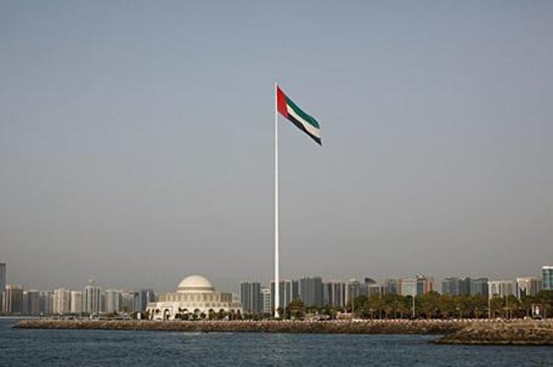 ABU DHABI, UNITED ARAB EMIRATES - June 18, 2009: The Abu Dhabi skyline and the UAE flag from a construction site next to Marina Mall in Abu Dhabi.

( Ryan Carter / The National )



*** For Magazine story on the UAE flag designer ***