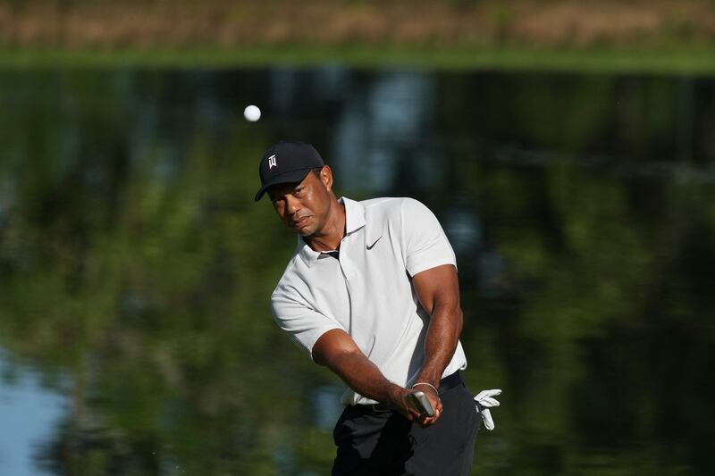 Tiger Woods chips on to the 11th green during a practice round for the PGA Championship. Reuters