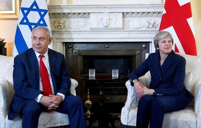 Britain's Prime Minister Theresa May, right, and Israel's Prime Minister Benjamin Netanyahu pose for photographers on the occasion of their meeting at 10 Downing Street, in London, Wednesday, June 6, 2018. (Toby Melville/Pool Photo via AP)