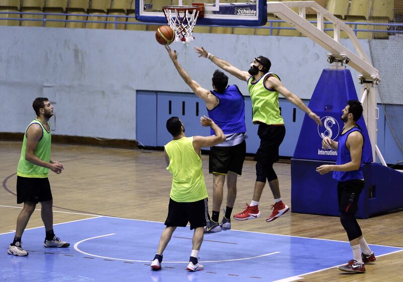 Syrian basketball team players take part in a training session at a stadium in Damascus on July 17, 2017. 
Since Syria's conflict erupted in March 2011, basketball player, Khalil Khoury, has seen his team's ranks dwindle and its options for training venues shrink. But it still practises and competes, including in the prestigious FIBA Asia Cup championship to held on August 17-27 in neighbouring Lebanon. Among the league's biggest challenges has been retaining talent, with players emigrating, doing their military service, or being injured or killed in the conflict. / AFP PHOTO / LOUAI BESHARA