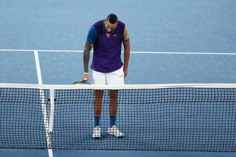 Nick Kyrgios inspects the net after a let call on his serve. PA