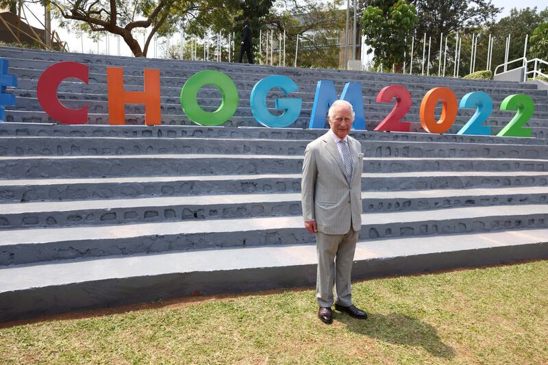 Prince Charles poses by 'CHOGM 2022' branding in Kigali. Reuters