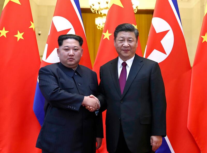 North Korean leader Kim Jong Un, left, and Chinese President Xi Jinping shake hands in Beijing, China. Ju Peng / Xinhua via AP