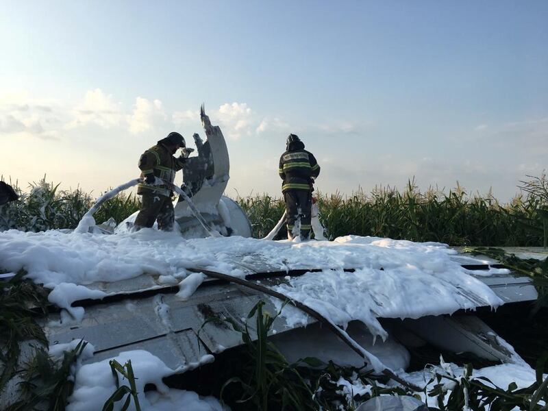 Firefighters spray foam on a wing of the Ural Airlines Airbus 321 passenger plane following an emergency landing. Reuters