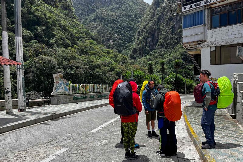 Tourists wait outside the Machu Picchu train station after the railway service was suspended due to damage allegedly caused by protesters. Peru closed the entrance to the Inca citadel on Saturday indefinitely, citing security reasons. AFP
