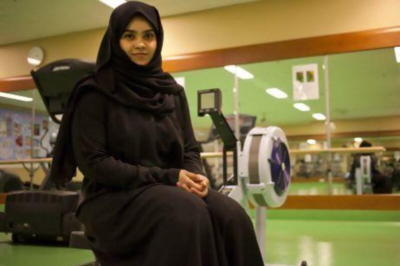 Huda Humood, 27, an Etisalat employee and student studying at Dubai Women's College, poses for a portrait at the fitness center of the college. Huda was a participant in the fitness competition and completed it in 12 minutes. Razan Alzayani/The National