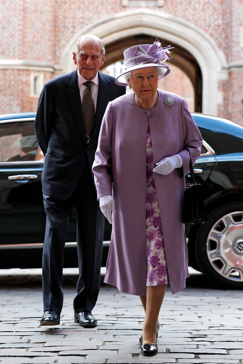 Queen Elizabeth II, wearing mauve, and Prince Philip, Duke of Edinburgh, arrive for Evensong in celebration of the centenary of the Order of the Companions of Honour at Hampton Court Palace on June 13, 2017, in London. Getty Images
