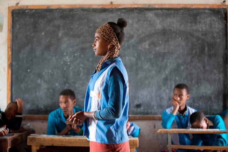 (FILES) This file photo taken on October 18, 2017 shows Zenashe Fantahun telling her experience about menstruation in front of a class at the Sheno primary school in Sheno, Ethiopia.
In partnership with UNICEF, the Sheno Primary School developed a programme with counselling on menstruation and sanitary pad for young student girls. Both male and female students participate in lessons on the girls menstruation for a better understanding and integration in schools.    / AFP PHOTO / Zacharias ABUBEKER