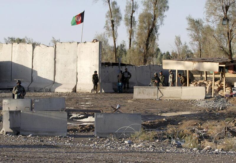 Afghan security forces stand guard at the entrance gate of Kandahar airport which was stormed by Taliban militants on December 9, 2015. At least 37 people were killed in the attack. Reuters