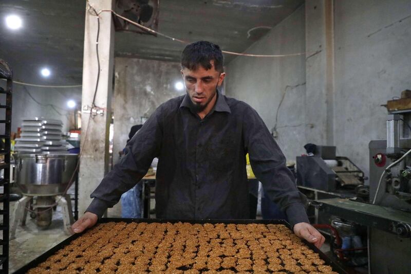 Traditional sweets being prepared at a bakery run by displaced Syrians in the town of Dana, east of the Turkish-Syrian border in the northwestern Idlib province. Aaref Watad / AFP