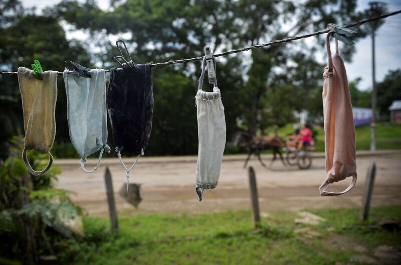 Face masks hang from a rope to dry at a house in Bahia Honda, Artemisa province, Cuba, amid the new coronavirus pandemic.  Cuba has controlled the pandemic, but its economic income, which is partially used to buy food, was affected by the lack of tourism. The island now faces a food shortage which it is trying to alleviate by increasing local production. AFP
