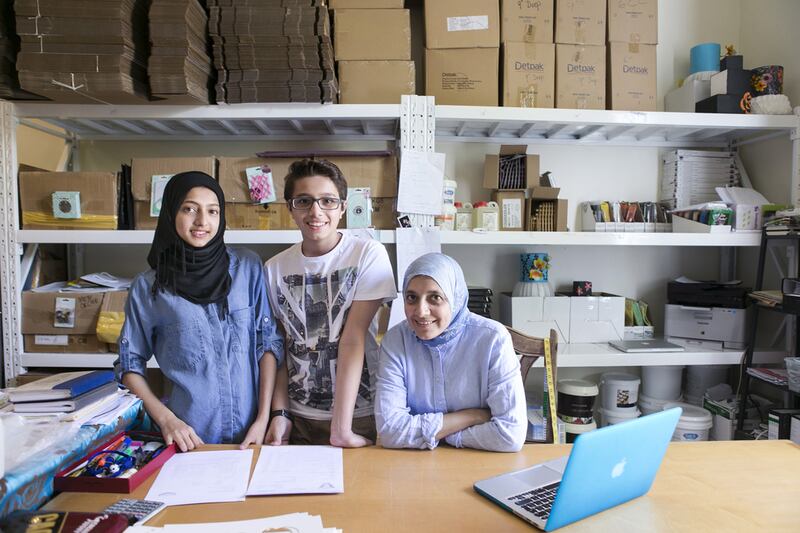 Serial entrepreneur Fatima Paruk with her children Husna, who is not keen on joining an SME when she graduates, and Mohammed. Reem Mohammed / The National