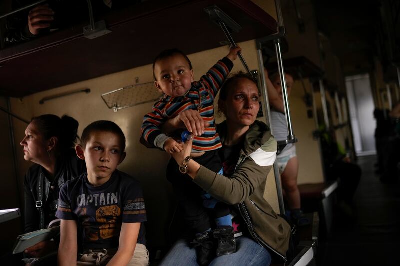 Yana Skakova and her son Yehor, who fled from Lysychansk, sit in an evacuation train in Pokrovsk, eastern Ukraine. AP