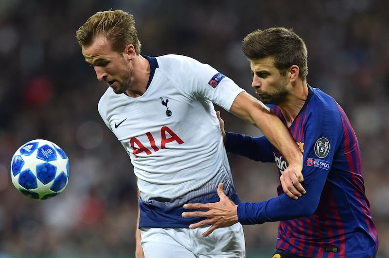 Tottenham Hotspur's Harry Kane vies with Barcelona's Gerard Pique. AFP