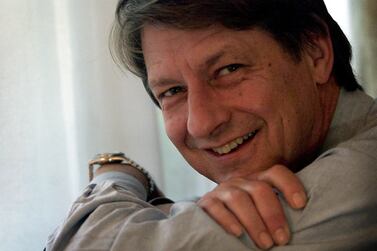 FILE PHOTO: P.J. O'Rourke, the American satirist who made his name with acerbic dispatches from war zones around the world, poses in his room at London's Duke's Hotel, September 27, 2001./File Photo