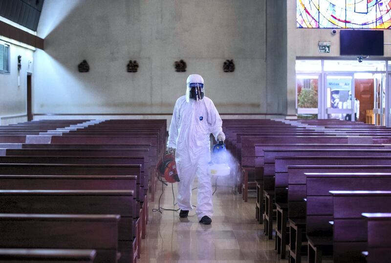 Abu Dhabi, United Arab Emirates, August 25, 2020.   
Social distancing and other Covid-19 measures are adhered to at the St. Joseph's Catholic Church in Abu Dhabi. --  A sanitation worker fumigates the prayer hall after the mass.
Victor Besa /The National
Section:  NA
Reporter:  Ramola Talwar
