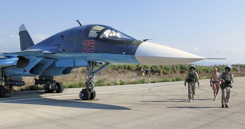 Russian pilots check their SU-34 bomber before taking off from the Syrian Hmeymim airbase, outside the province of Latakia, in this handout photo dated October 3, 2015. Russian Defence Ministry Press Service/Handout/EPA 