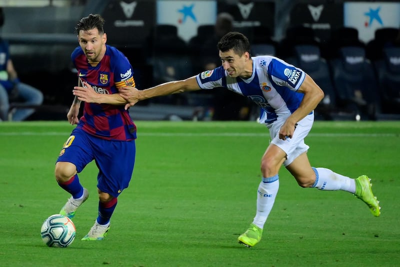 Lionel Messi shrugs off a challenge from Espanyol's Marc Roca. AFP