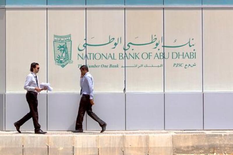 Abu Dhabi, United Arab Emirates, July 31, 2012:    Men outside the National Bank of Abu Dhabi NBAD branch at the intersection of Murrour and 15th streets in Abu Dhabi on July 31, 2012. Christopher Pike / The National