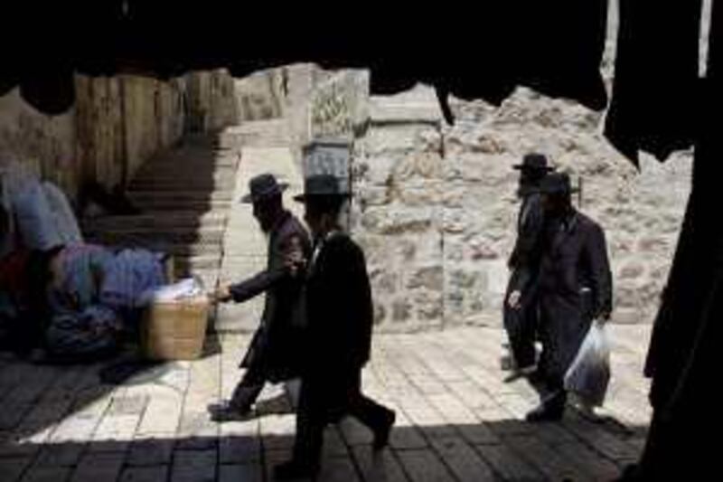 Ultra-Orthodox Jewish men walk in Jerusalem's Old City June 8, 2009. U.S. President Barack Obama wants "immediate" talks between the Palestinians and Israel to forge a comprehensive Middle East peace agreement, U.S. envoy George Mitchell said on Monday. Israeli Prime Minister Benjamin Netanyahu has said he is ready to meet Palestinian President Mahmoud Abbas and pursue a three-track peace process focusing on economic, security and political issues. Abbas has said renewed negotiations would be pointless unless Netanyahu first endorsed the U.S.-backed goal of Palestinian statehood and halted, as Obama has demanded, the expansion of Jewish settlements in the occupied West Bank. REUTERS/Ammar Awad (JERUSALEM POLITICS)