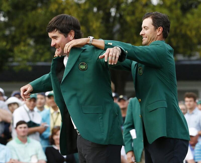 Defending Masters Champion Adam Scott of Australia, right, helps Bubba Watson of the US into his second green jacket after winning the 2014 Masters Tournament at the Augusta National Golf Club in Augusta, Georgia, USA, 13 April 2014. EPA/ERIK S. LESSER