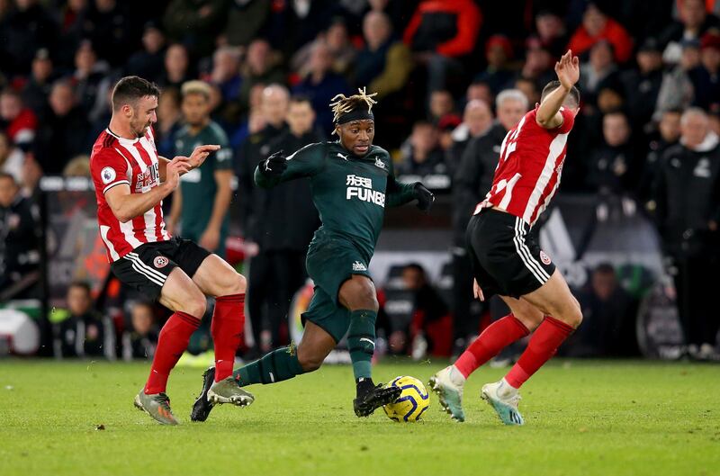 SHEFFIELD, ENGLAND - DECEMBER 05: Enda Stevens (L) and John Egan (R) of Sheffield challenge Allan Saint Maximin (C) of Newcastle during the Premier League match between Sheffield United and Newcastle United at Bramall Lane on December 05, 2019 in Sheffield, United Kingdom. (Photo by Alex Livesey/Getty Images)