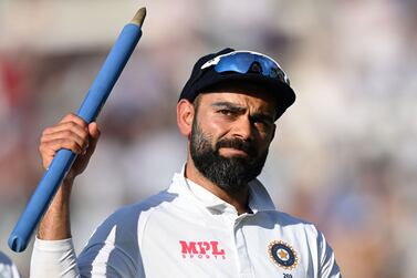 (FILES) In this file photo taken on September 6, 2021, India's captain Virat Kohli holds aloft a stump as he leaves the field after India won the fourth cricket Test match between England and India at the Oval cricket ground in London.  - Kohli announced on January 15, 2022 he was stepping down as Test captain, a day after his side lost a three-match series to South Africa.  (Photo by Glyn KIRK / AFP) / RESTRICTED TO EDITORIAL USE.  NO ASSOCIATION WITH DIRECT COMPETITOR OF SPONSOR, PARTNER, OR SUPPLIER OF THE ECB