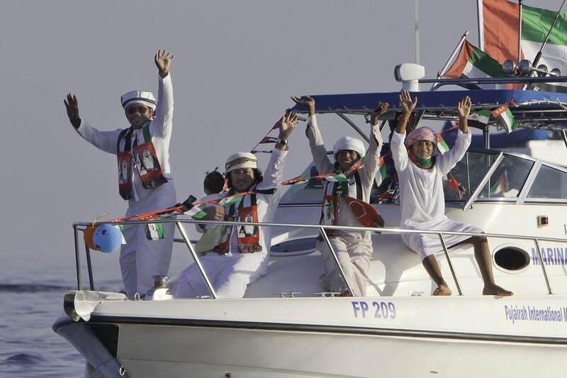 Young Emiratis participate in a boat parade in Fujairah marking the 42nd UAE National Day. Jaime Puebla / The National