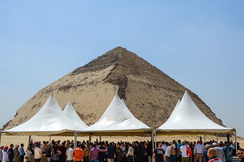 People gather during an inaugural ceremony in front of the Bent pyramid of King Sneferu. AFP