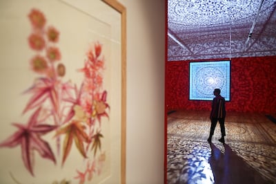Pakistani-American artist Anila Quayyum Agha walks through her work All the Flowers are for Me at Kew Gardens in London, on March 30. EPA